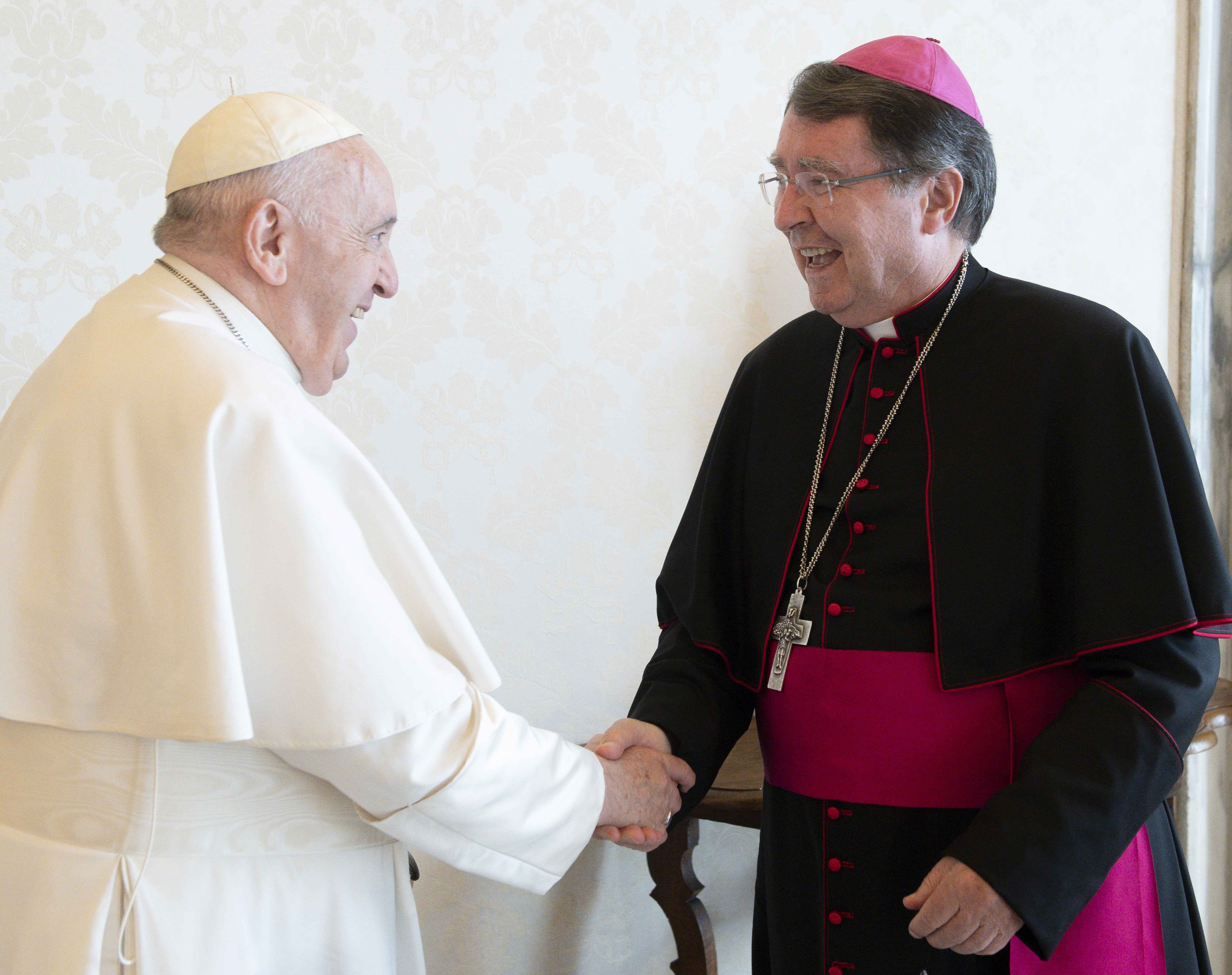 Pope Francis shakes hands with Archbishop Christophe Pierre.