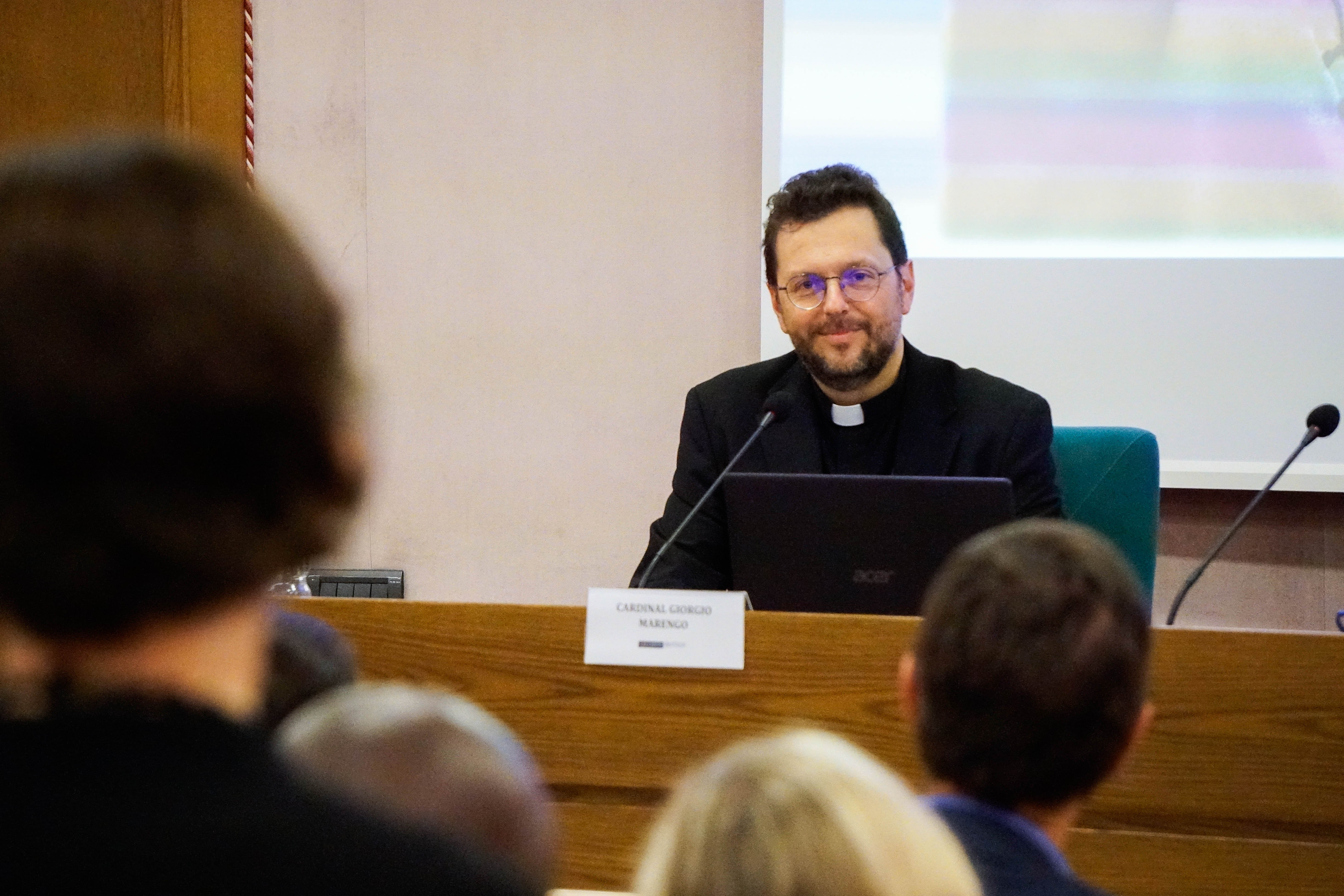 Cardinal Giorgio Marengo listens to a question at a conference.